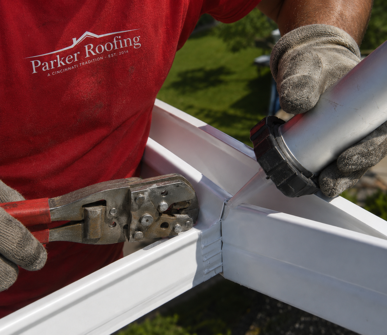 Parker Roofing crew installing seamless gutters on a Cincinnati home